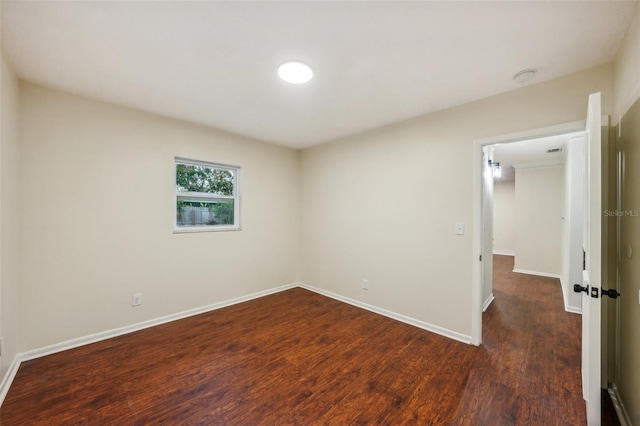 empty room with dark hardwood / wood-style flooring