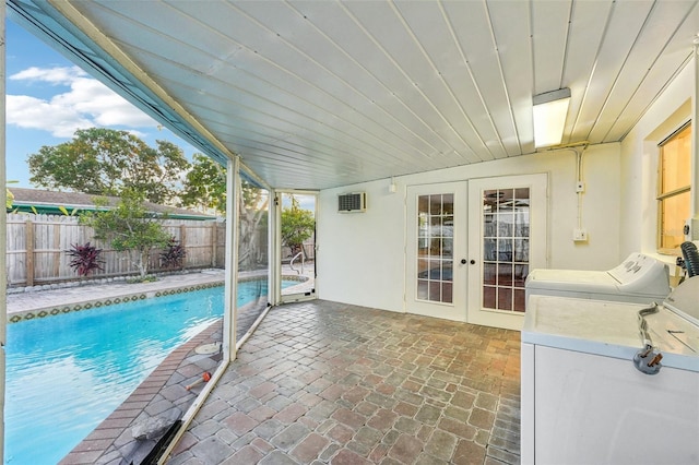 view of swimming pool with french doors, a patio, and washer / dryer