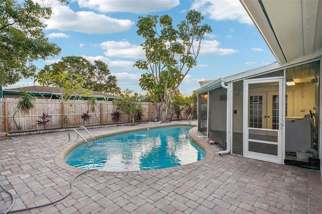 view of pool with a patio area and french doors