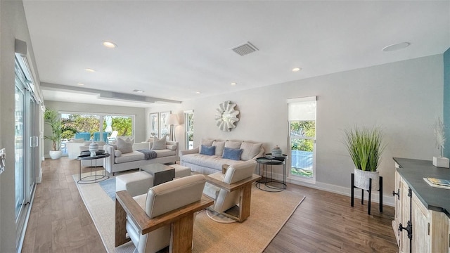 living room featuring light hardwood / wood-style floors and a healthy amount of sunlight