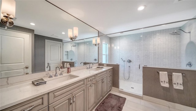 bathroom with tile patterned floors, vanity, a notable chandelier, and walk in shower