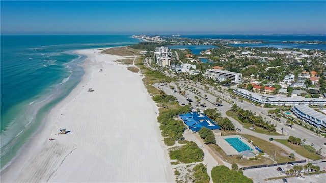 drone / aerial view featuring a water view and a beach view