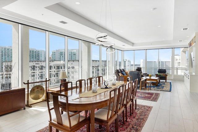 sunroom / solarium with a tray ceiling