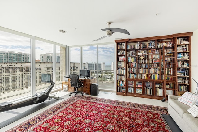 interior space featuring ceiling fan, floor to ceiling windows, and light hardwood / wood-style flooring