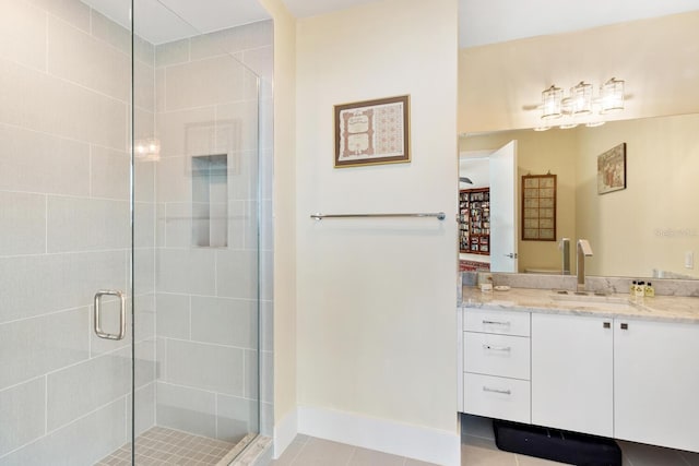 bathroom featuring tile patterned flooring, vanity, and a shower with door