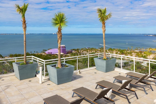 view of patio with a water view and a balcony