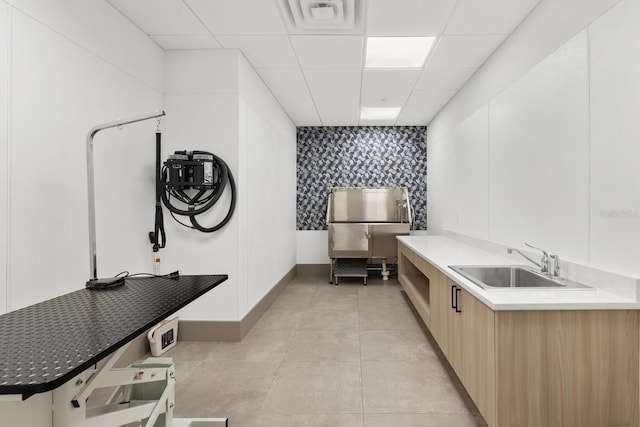 kitchen with a paneled ceiling and sink