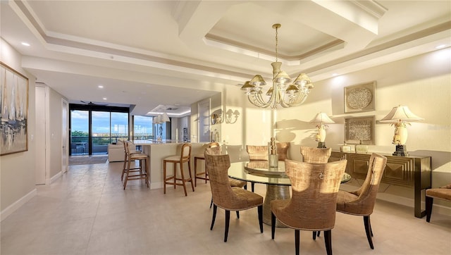 dining space featuring a raised ceiling and a notable chandelier