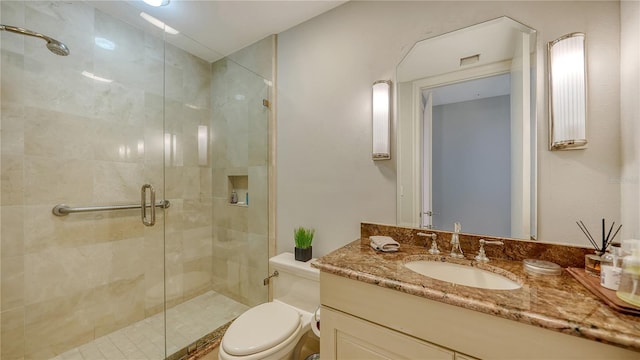 bathroom with walk in shower, vanity, and toilet