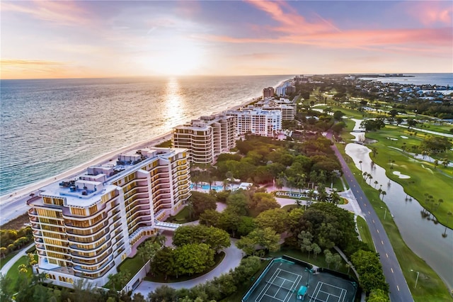 aerial view at dusk featuring a water view