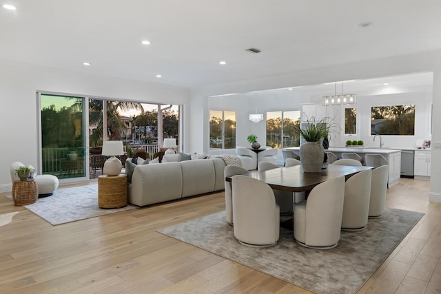 dining area featuring light wood-type flooring and sink