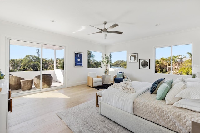 bedroom featuring access to exterior, multiple windows, light hardwood / wood-style flooring, and ceiling fan