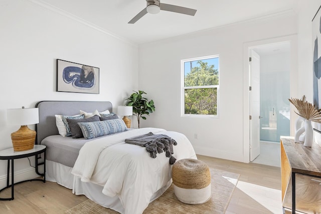 bedroom featuring ensuite bathroom, light hardwood / wood-style flooring, ceiling fan, and ornamental molding