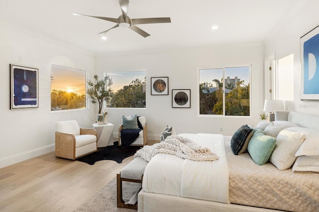 bedroom featuring ceiling fan, crown molding, and light hardwood / wood-style floors