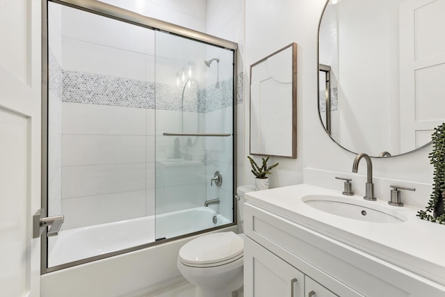 full bathroom with vanity, toilet, and enclosed tub / shower combo