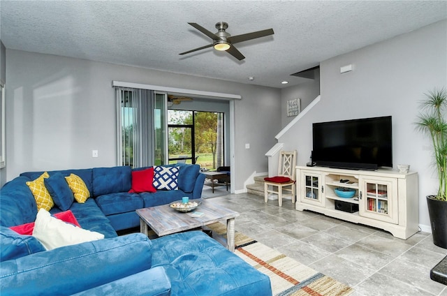 living room with ceiling fan and a textured ceiling