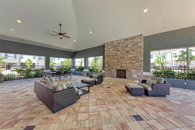 view of patio featuring an outdoor living space with a fireplace and ceiling fan