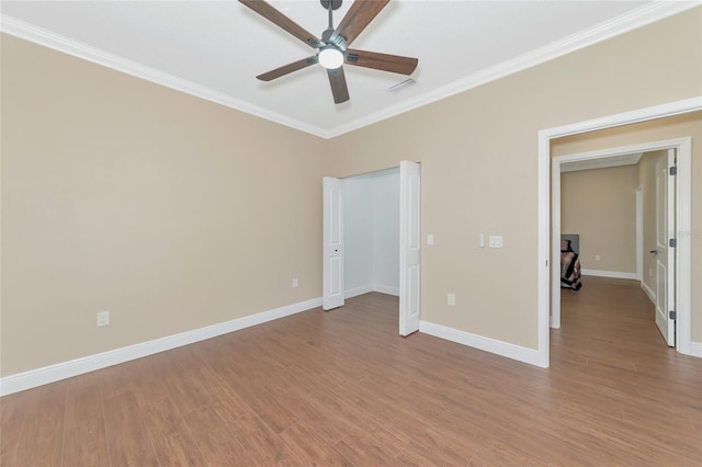 unfurnished bedroom with ceiling fan, light hardwood / wood-style floors, and ornamental molding