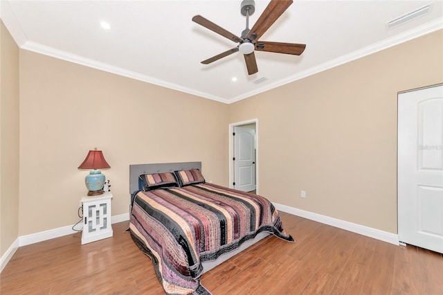 bedroom with ceiling fan, ornamental molding, and light wood-type flooring