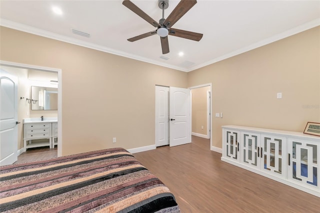 bedroom featuring ceiling fan, wood-type flooring, crown molding, and ensuite bath