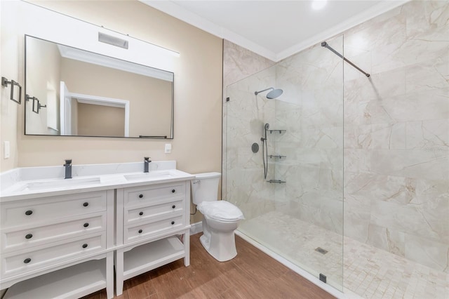 bathroom featuring tiled shower, wood-type flooring, and ornamental molding