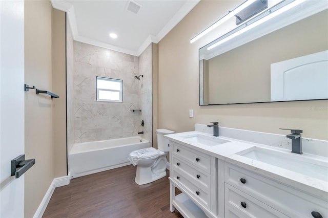 full bathroom with crown molding, toilet, hardwood / wood-style flooring, vanity, and tiled shower / bath