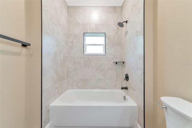 bathroom with tiled shower / bath combo and toilet