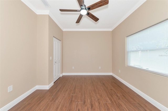 empty room with crown molding, ceiling fan, and wood-type flooring