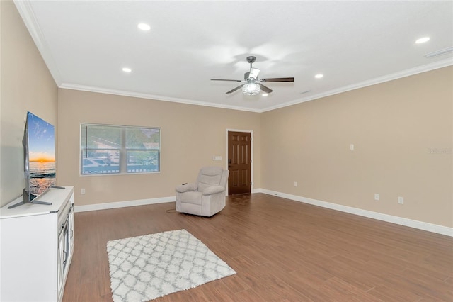 sitting room featuring hardwood / wood-style floors, ceiling fan, and crown molding