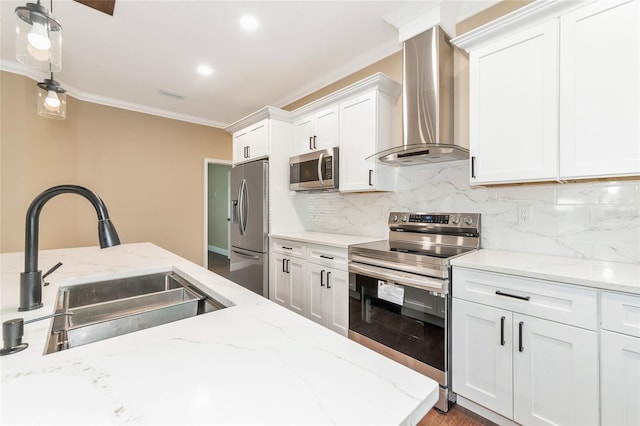 kitchen featuring light stone countertops, wall chimney exhaust hood, stainless steel appliances, sink, and white cabinetry