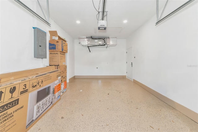 garage with electric panel and a garage door opener