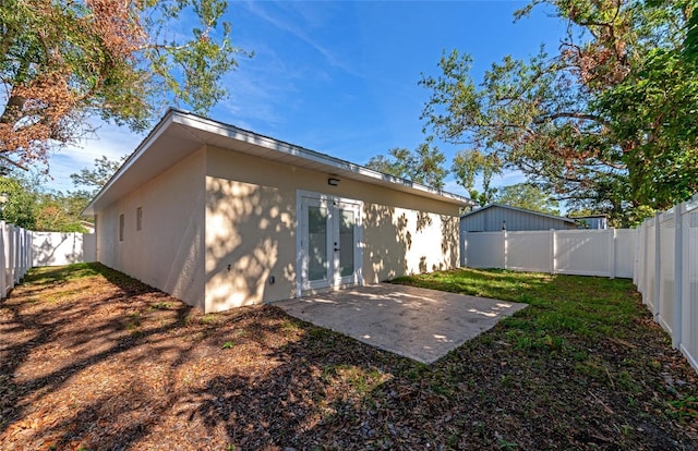 rear view of house with a patio area and a yard