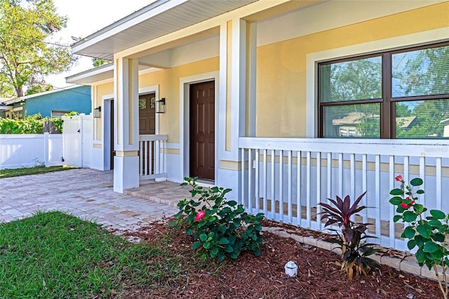 view of exterior entry featuring a porch