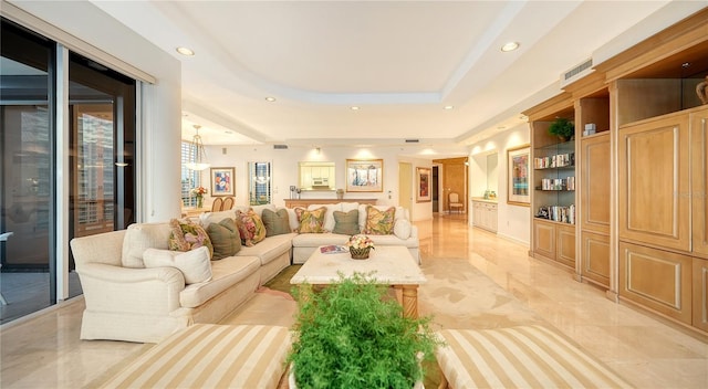 living room featuring a raised ceiling