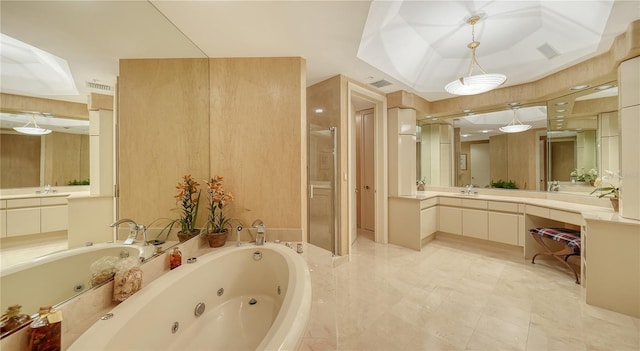 bathroom with vanity, a tray ceiling, and separate shower and tub