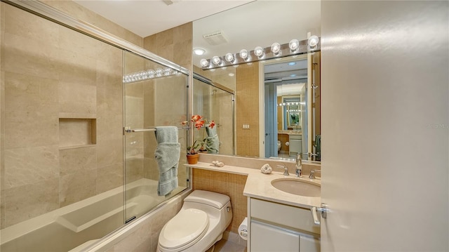 full bathroom featuring vanity, toilet, and enclosed tub / shower combo