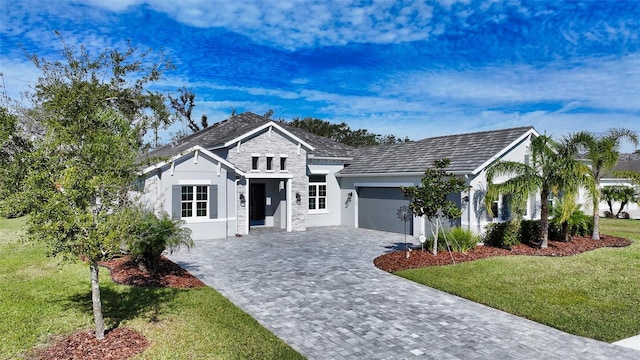 view of front of home featuring a garage and a front lawn