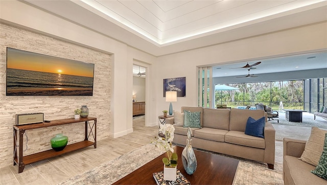 living room with ceiling fan and light hardwood / wood-style floors