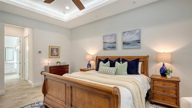 bedroom featuring ceiling fan, light wood-type flooring, and ensuite bath