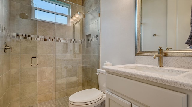 bathroom featuring vanity, toilet, and walk in shower