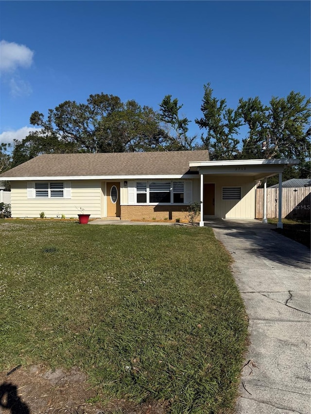 ranch-style home with a front yard and a carport