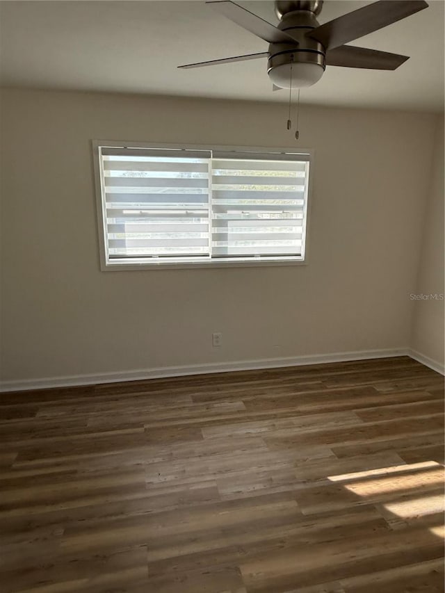 spare room featuring ceiling fan and dark hardwood / wood-style floors