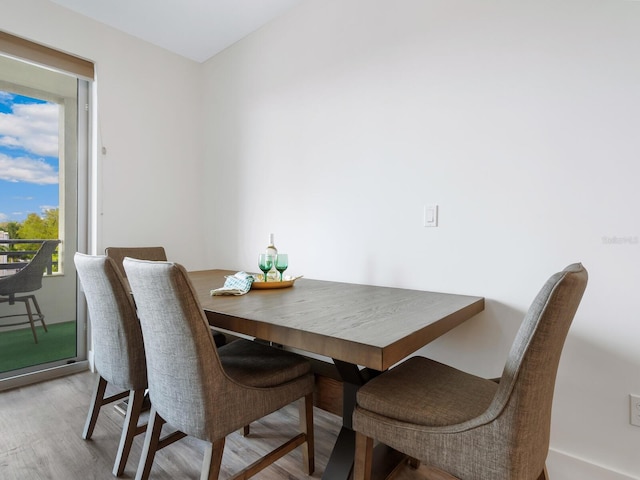 dining space with light hardwood / wood-style floors