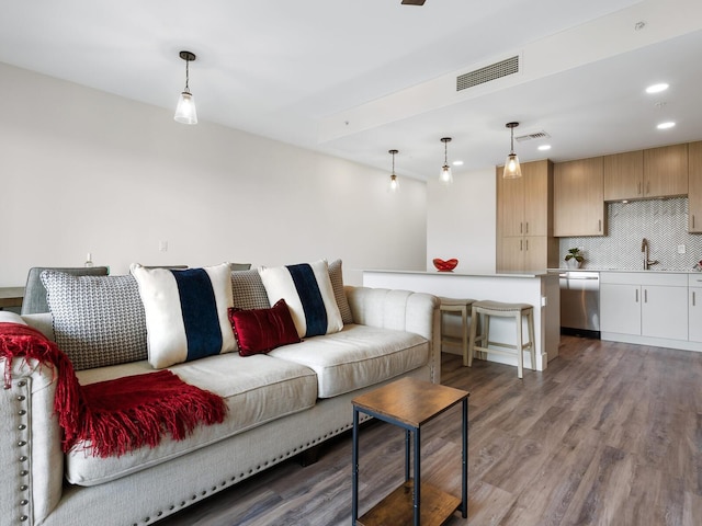 living room featuring hardwood / wood-style flooring and sink