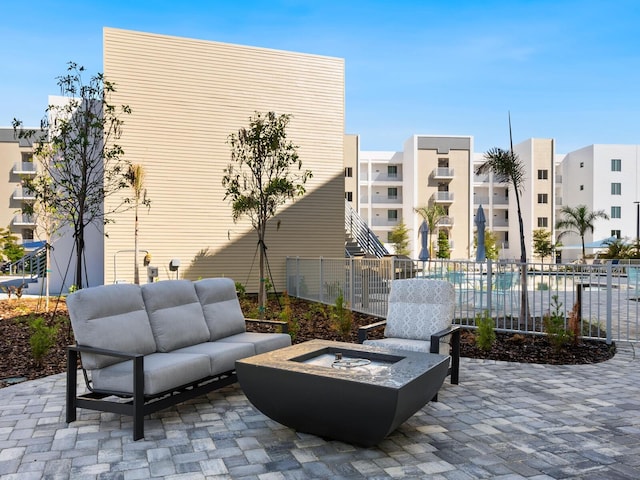 view of patio / terrace featuring an outdoor living space with a fire pit