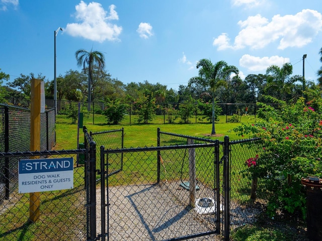 view of gate featuring a yard