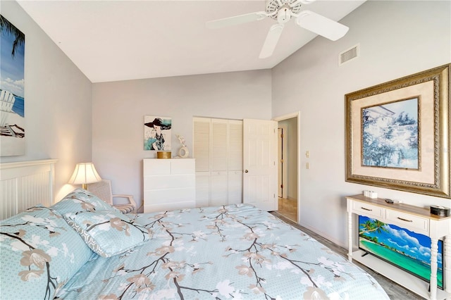 bedroom with wood-type flooring, vaulted ceiling, a closet, and ceiling fan