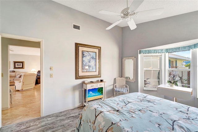 bedroom with ceiling fan and a textured ceiling