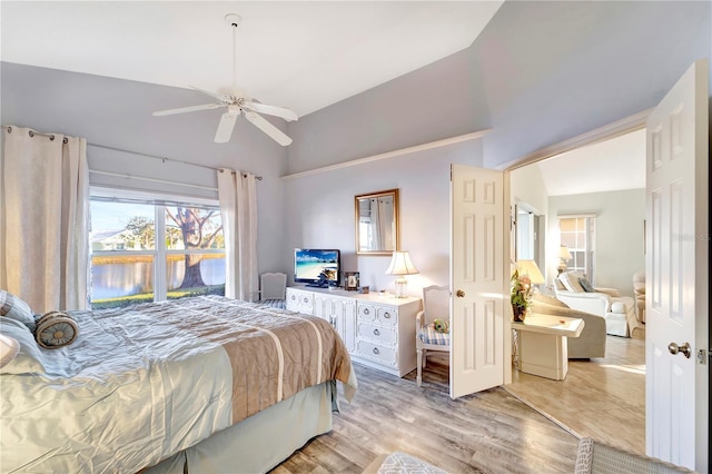 bedroom featuring vaulted ceiling, ceiling fan, and light wood-type flooring