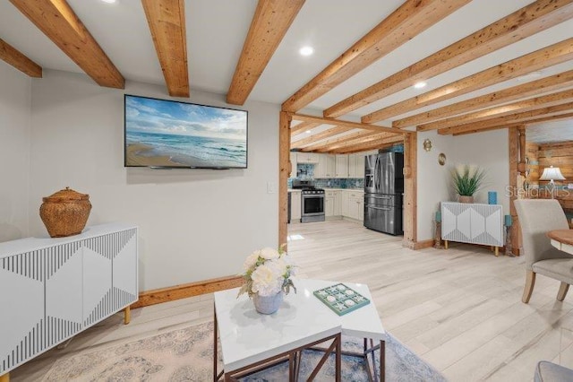 living room featuring beamed ceiling, light hardwood / wood-style floors, and radiator heating unit